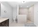 Modern bathroom with walk in shower and dark wood vanity with marble top at 7335 Treyland Ct, Cumming, GA 30041