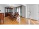 Dining area featuring hardwood floors, elegant furnishings, and access to a front entrance at 7335 Treyland Ct, Cumming, GA 30041