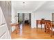 Elegant foyer showcasing gleaming hardwood floors, a chandelier, and seamless flow into the living spaces at 7335 Treyland Ct, Cumming, GA 30041