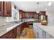 Bright kitchen featuring granite countertops, stainless appliances, cherry cabinets and hardwood floors at 7335 Treyland Ct, Cumming, GA 30041