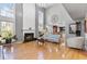 Bright living room featuring hardwood floors, fireplace, tall windows, and open layout at 7335 Treyland Ct, Cumming, GA 30041