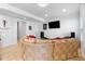 Bright living room with tile floors, large sectional sofa, and television at 7335 Treyland Ct, Cumming, GA 30041