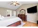 Spacious bedroom featuring hardwood floors, a large window, and flat screen TV at 7335 Treyland Ct, Cumming, GA 30041