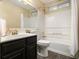 Bathroom featuring a vanity with dark wood cabinets and a shower-tub combination at 110 Windsor Chase Dr, Lawrenceville, GA 30043