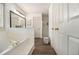 Bathroom with soaking tub, white cabinets and a glass-enclosed shower at 110 Windsor Chase Dr, Lawrenceville, GA 30043