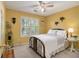 Bedroom featuring warm yellow walls, a window with shutters, and comfortable furnishings at 110 Windsor Chase Dr, Lawrenceville, GA 30043