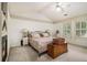 Bedroom featuring a fireplace, ceiling fan and neutral colored decor at 110 Windsor Chase Dr, Lawrenceville, GA 30043