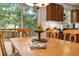 Close-up on a wooden dining table set in a bright room with views of the yard at 110 Windsor Chase Dr, Lawrenceville, GA 30043