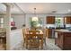 Bright dining area with wooden table and chairs, open to kitchen, and great outdoor views at 110 Windsor Chase Dr, Lawrenceville, GA 30043