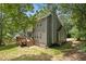 Rear view of a two-story house with gray siding, a wooden deck, and mature trees at 110 Windsor Chase Dr, Lawrenceville, GA 30043