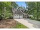 Well-maintained home featuring a two-car garage and mature trees at 110 Windsor Chase Dr, Lawrenceville, GA 30043