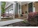 Charming front porch featuring a cozy swing and brick accents at 110 Windsor Chase Dr, Lawrenceville, GA 30043