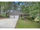 Inviting home exterior with a two-car garage and beautiful landscaping at 110 Windsor Chase Dr, Lawrenceville, GA 30043