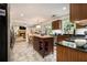 Bright kitchen featuring stone flooring, a central island, stainless steel appliances, and dark countertops at 110 Windsor Chase Dr, Lawrenceville, GA 30043