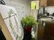 Close-up on black countertops with leafy decor, a stainless sink, and modern white subway tile backsplash at 110 Windsor Chase Dr, Lawrenceville, GA 30043
