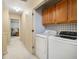 Laundry room with a washer, dryer and storage cabinets at 110 Windsor Chase Dr, Lawrenceville, GA 30043