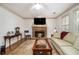 Inviting living room featuring fireplace, hardwood floors, neutral furniture, area rug, and natural light at 110 Windsor Chase Dr, Lawrenceville, GA 30043