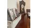 Close up of shelf decor including books and an antique clock at 110 Windsor Chase Dr, Lawrenceville, GA 30043