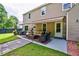 Inviting back patio with awning features comfortable seating, perfect for outdoor relaxation and entertaining at 5388 Silver Springs Dr, Sugar Hill, GA 30518