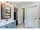 Bathroom with double vanity, large mirror and toilet in separate room at 5388 Silver Springs Dr, Sugar Hill, GA 30518