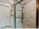 Modern bathroom with stand-up shower, glass door, and built-in shelves for storage at 5388 Silver Springs Dr, Sugar Hill, GA 30518