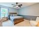 Comfortable bedroom with a queen size bed, carpet flooring, and lots of natural light at 5388 Silver Springs Dr, Sugar Hill, GA 30518