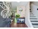 Elegant foyer with hardwood floors, stylish decor, and staircase at 5388 Silver Springs Dr, Sugar Hill, GA 30518