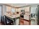 Modern kitchen with white cabinets, granite countertops, and stainless steel appliances at 5388 Silver Springs Dr, Sugar Hill, GA 30518