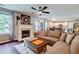 Open concept living room with hardwood floors, fireplace, comfortable seating, and lots of natural light at 5388 Silver Springs Dr, Sugar Hill, GA 30518