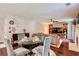 Cozy living room and dining area features an open plan, hard wood floors and modern ceiling fan at 5388 Silver Springs Dr, Sugar Hill, GA 30518