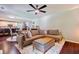 Comfortable living room with hardwood floors, a modern ceiling fan and an attached kitchen and dining area at 5388 Silver Springs Dr, Sugar Hill, GA 30518