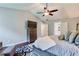 The spacious primary bedroom has hardwood floors, a ceiling fan, and large TV at 5388 Silver Springs Dr, Sugar Hill, GA 30518