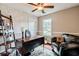 Cozy office space with a desk, chair, bookshelf, and a comfortable leather sofa at 5388 Silver Springs Dr, Sugar Hill, GA 30518