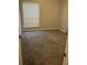 Bedroom with gray walls, gray carpeting, a window with blinds, and white trim at 5540 Kingsport Ne Dr # 18, Atlanta, GA 30342