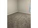 Bedroom featuring gray walls, base trim, and gray carpeting at 5540 Kingsport Ne Dr # 18, Atlanta, GA 30342
