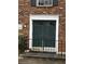 Front door of brick building featuring black shutters and black iron handrail at 5540 Kingsport Ne Dr # 18, Atlanta, GA 30342