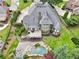 Aerial view of a beautiful property with a gray roof and large backyard with a private pool at 219 Deer Park Trl, Canton, GA 30114