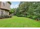 Lush backyard with a well-maintained lawn, mature trees, and manicured landscaping at 219 Deer Park Trl, Canton, GA 30114