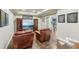 Finished basement with two leather chairs, flat screen TV, and elegant wood cabinets for storage and media entertainment at 219 Deer Park Trl, Canton, GA 30114
