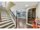 Finished basement featuring staircase, hardwood floors, stylish lighting, and a classic display cabinet at 219 Deer Park Trl, Canton, GA 30114