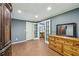 Basement bedroom with double doors to the basement living area, hardwood floors and traditional furniture at 219 Deer Park Trl, Canton, GA 30114