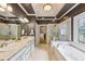 Spacious bathroom with double sinks, a separate tub, a glass shower, and a walk-in closet at 219 Deer Park Trl, Canton, GA 30114