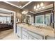 Bathroom featuring double sinks, bathtub with window, and access to the main bedroom at 219 Deer Park Trl, Canton, GA 30114