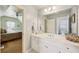 Bathroom with double vanity, large mirror, and view into bedroom, creating a functional and connected space at 219 Deer Park Trl, Canton, GA 30114
