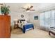 Bedroom featuring a bed with blue accents, a ceiling fan, and natural light from the window at 219 Deer Park Trl, Canton, GA 30114