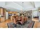 Spacious dining room with a stone fireplace, hardwood floors, and stylish chandelier at 219 Deer Park Trl, Canton, GA 30114