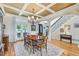 Elegant dining room with coffered ceilings, chandelier, and hardwood floors at 219 Deer Park Trl, Canton, GA 30114