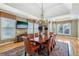 Well-lit dining room featuring a large table with seating for eight and a tray ceiling at 219 Deer Park Trl, Canton, GA 30114