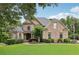 Charming brick home with manicured lawn, mature trees, and beautiful landscaping at 219 Deer Park Trl, Canton, GA 30114
