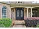Elegant entryway with ornate wrought iron double doors and brick detailing at 219 Deer Park Trl, Canton, GA 30114